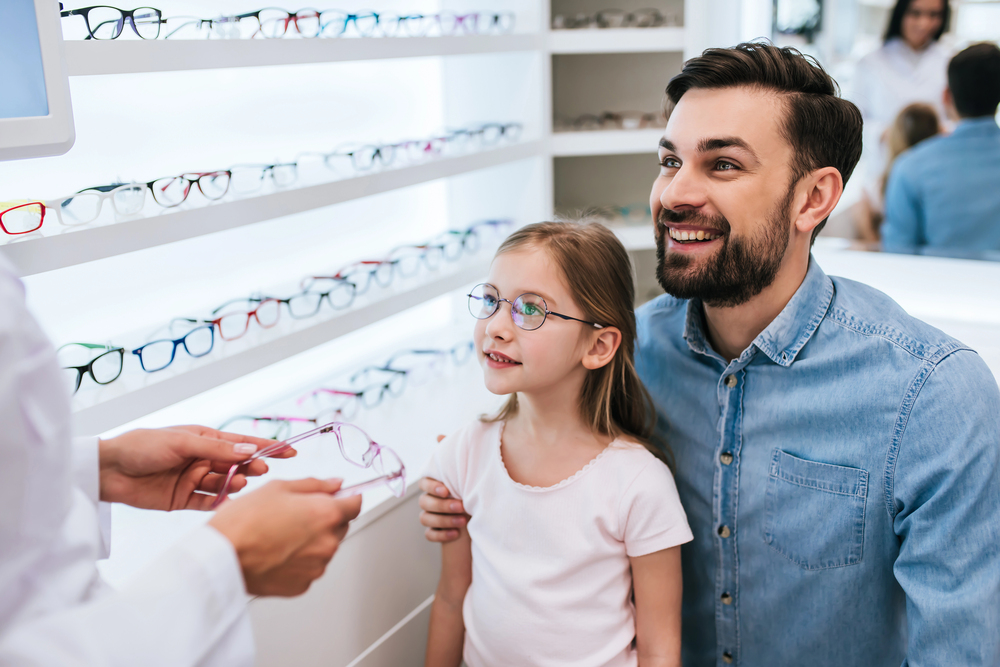 Father and daughter selecting eyeglasses at Tulsa optical shop