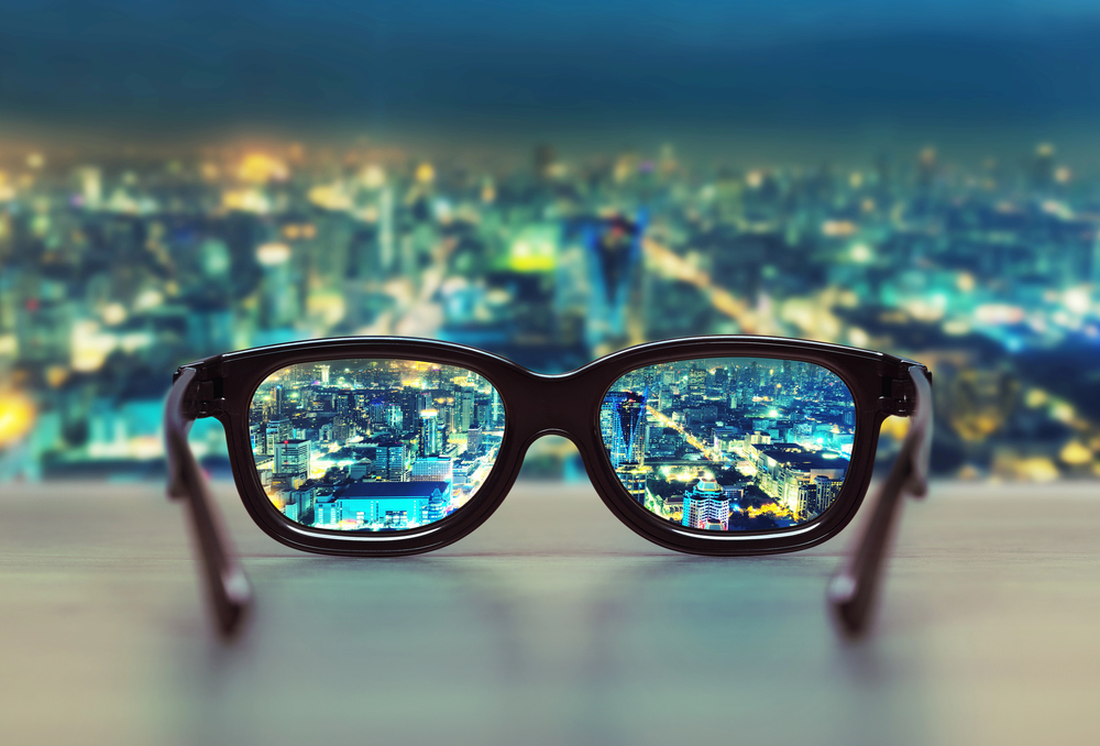 Glasses showing clear vision versus blurry background, demonstrating myopia correction