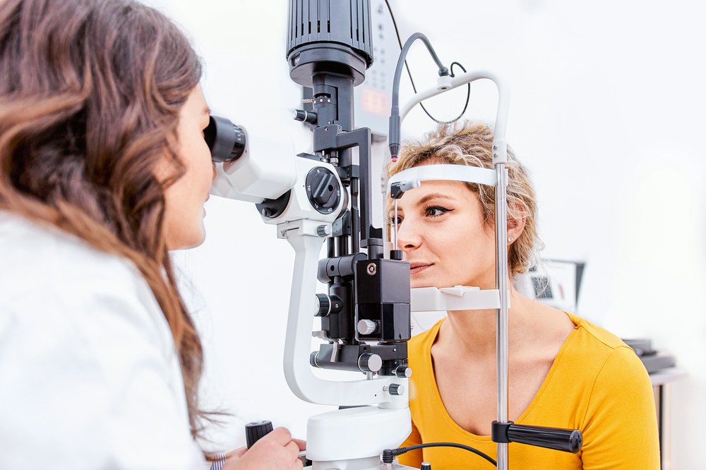 Woman receiving comprehensive eye exam with slit lamp in Tulsa optometry office
